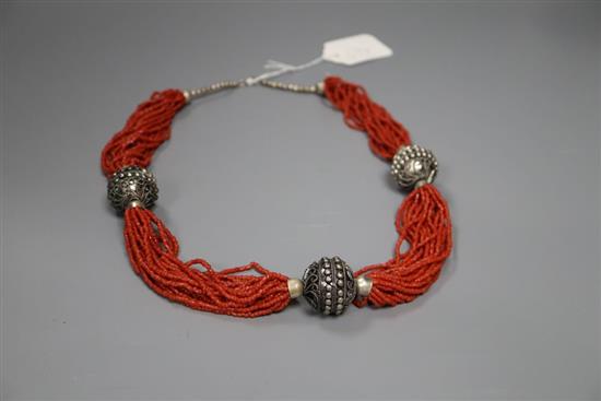 An Eastern white metal and multi strand coral bead necklace, 65cm.